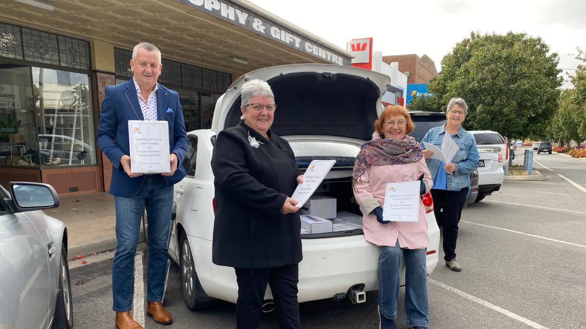 NEW: Members Tony Reneker, Wendy Senti, Jeanette Petts and Lyn Middleton prepare to deliver some of the books. Photo: Talia Pattison