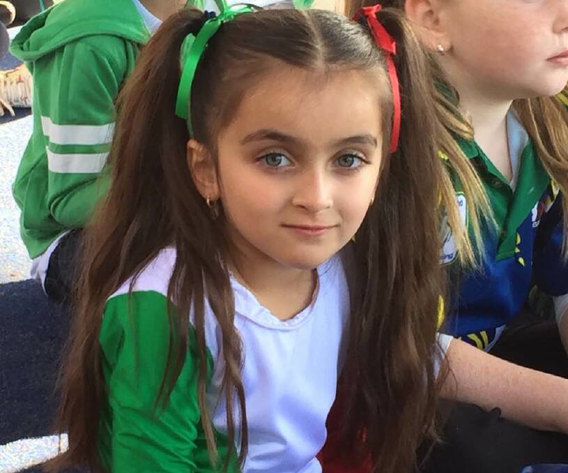 IN THE SPIRIT: Domenica Piccolo dressed in green, white and red to mark Italian Republic Day during celebrations at St Joseph's Primary School. 