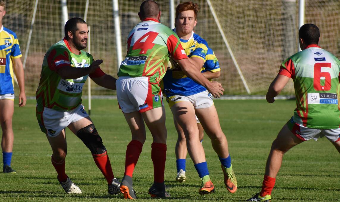 WRAPPED UP: Brandon Catlin runs into the defensive line during last week's round five matches at the town ovals. Photo: Shaun Paterson 