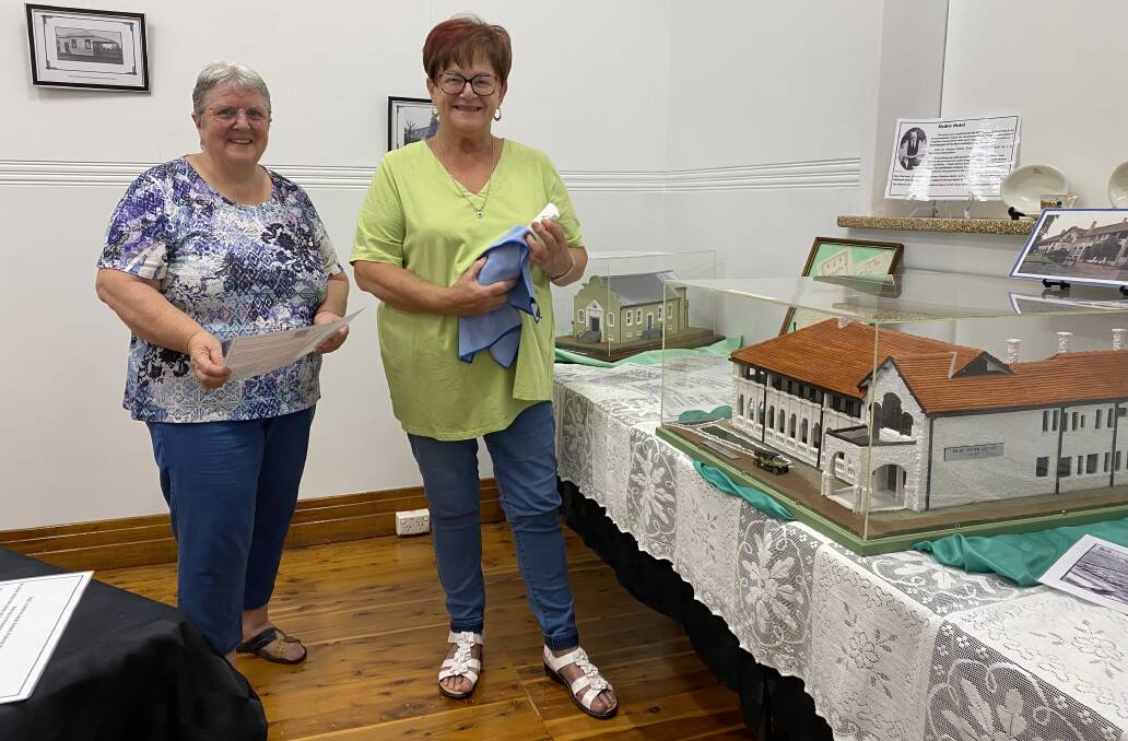Leeton Family and Local History Society's Wendy Senti (left) and Mal Page prep the exhibition before it opened on Monday, January 22. Picture by Talia Pattison