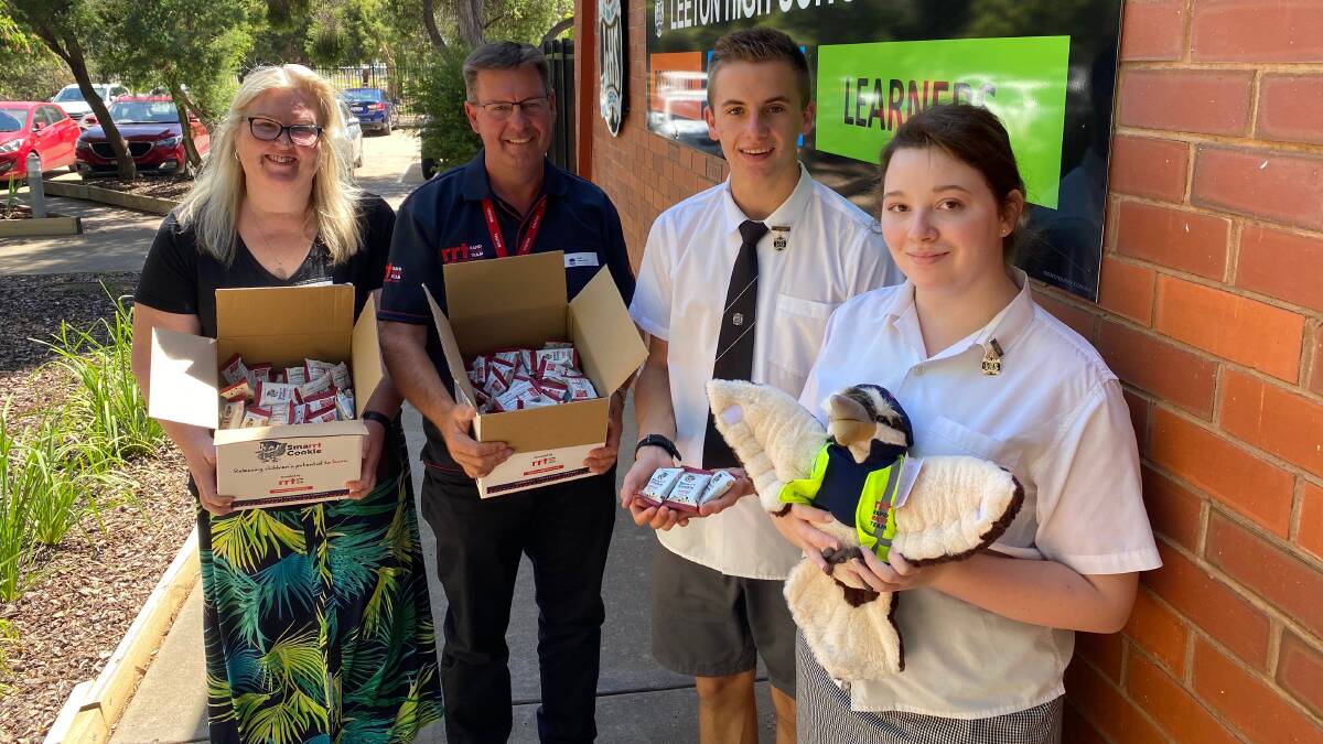 DELIVERY: Leeton High School's head teacher of welfare Tracey Byrne (left) and school captains Jhie Deaton and Meghan Davidson-Curtain accept the bars from Rod Martin from the Rapid Relief Team. Photo: Talia Pattison