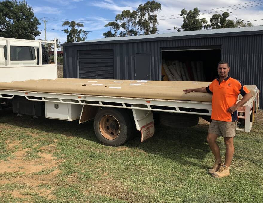 READY TO GO: Leeton Junior Rugby League president Matt Evans with the new goal posts before they were unloaded at the Leeton High School ovals. 