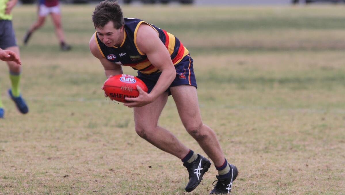 NEXT CHALLENGE: Tom Handsaker scoops up the ball for the Crows during last weekend's match against GGGM. Photo: Talia Pattison 