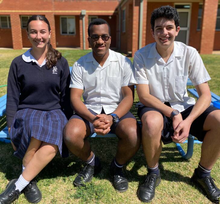 ALL SMILES: St Francis year 12 students Imogen Wilkes-Bowes, Chindu Rihuarulam and Luke Fiumara. Photo: Talia Pattison 