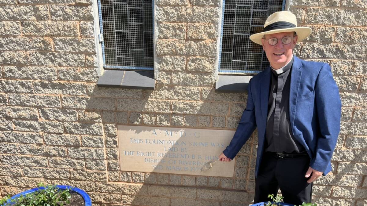 Father Robert Murphy displays the foundation stone at St Peter's Anglican Church. Picture by Talia Pattison