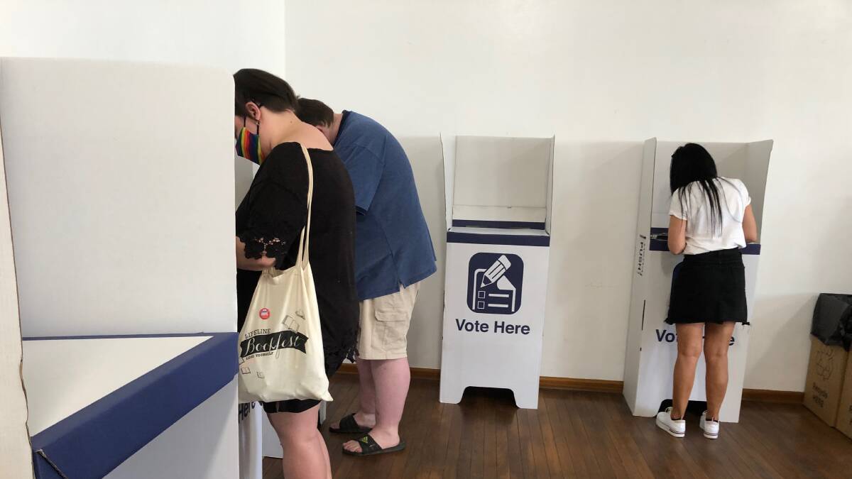 DECISION TIME: Residents cast their vote at the Madonna Place polling booth on Saturday. Photo: Talia Pattison