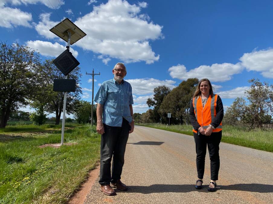 SAFETY: Leeton Shire Council mayor Paul Maytom with road safety officer Steph Puntoriero displaying the new signage, which is activated by vehicles on approach to the intersection. Photo: Talia Pattison