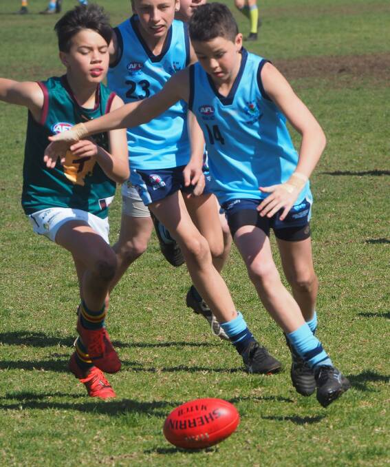 EYE ON THE PRIZE: Tallis McMillan races to scoop up the ball. Photo: Contributed