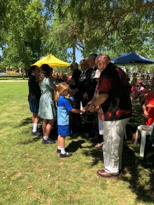 Students sing to and shake the hands of Leeton's veterans. 