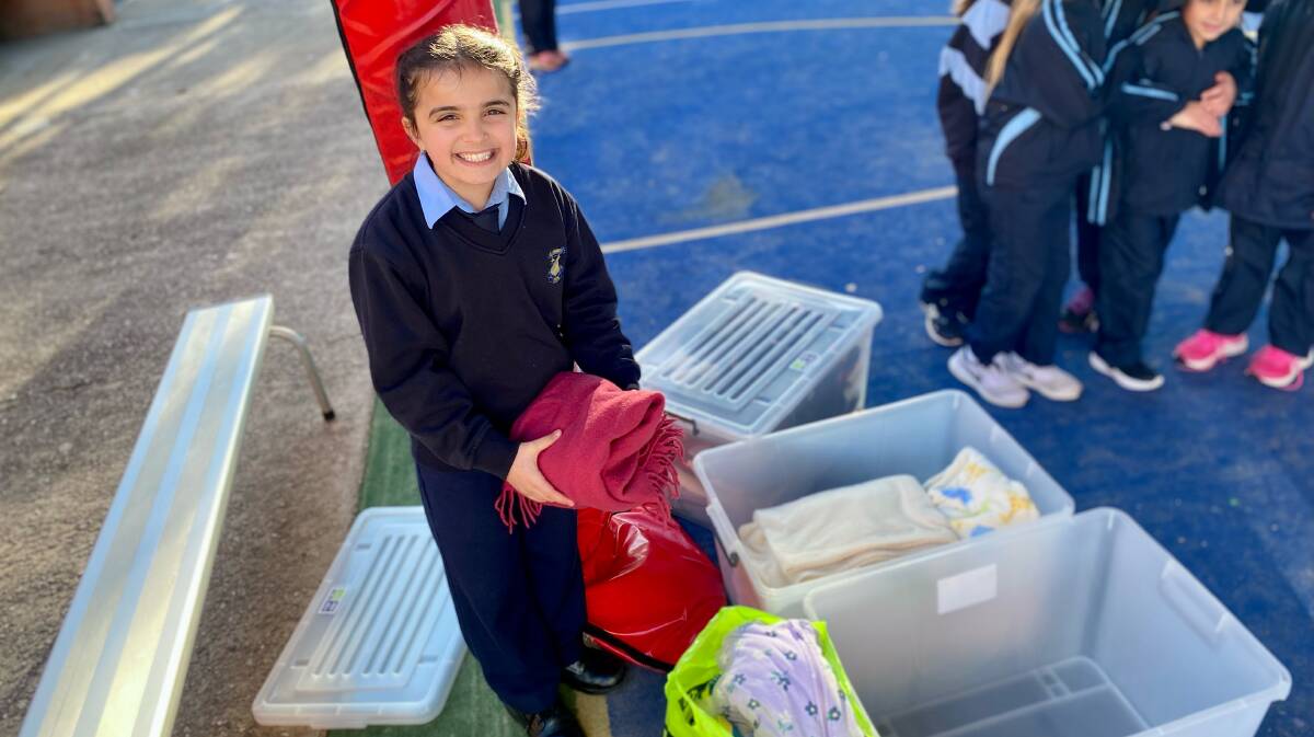 HUGE EFFORT: St Joseph's Primary School student Gisella Piccolo collects donations. Photo: Supplied