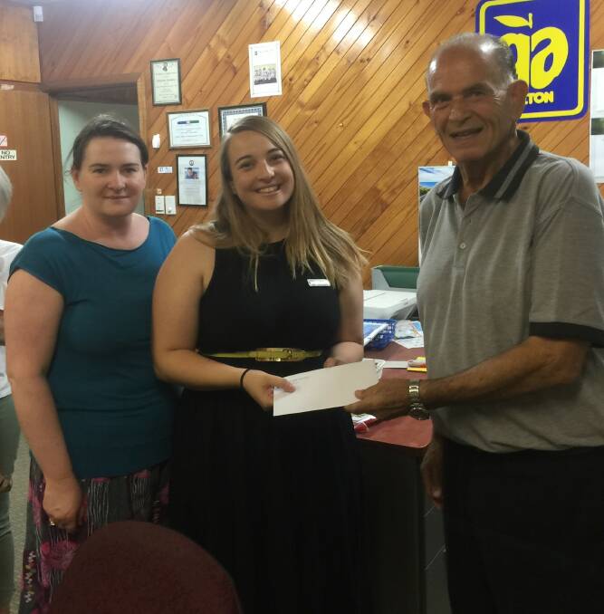 WORTHY CAUSE: Yanco CWA members Hannah Blackburn and Tessa Hamilton accept the donation from Angelo Fiumara.