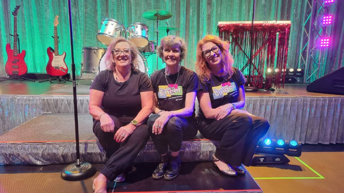 Robyn Hutchinson (middle) with sewist Katie Hume (left) and Cynthia Arel on the set of The Wedding Singer in Griffith last year. Picture by John Silvestro 
