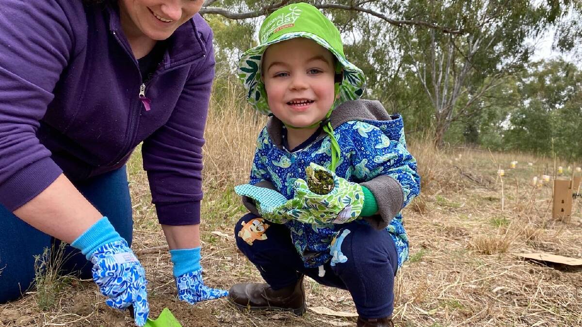 HELP OUT: Young green thumb Locky Farlow takes part in the Naitonal Tree Day event at the Narrandera Wetlands. Photo: Supplied