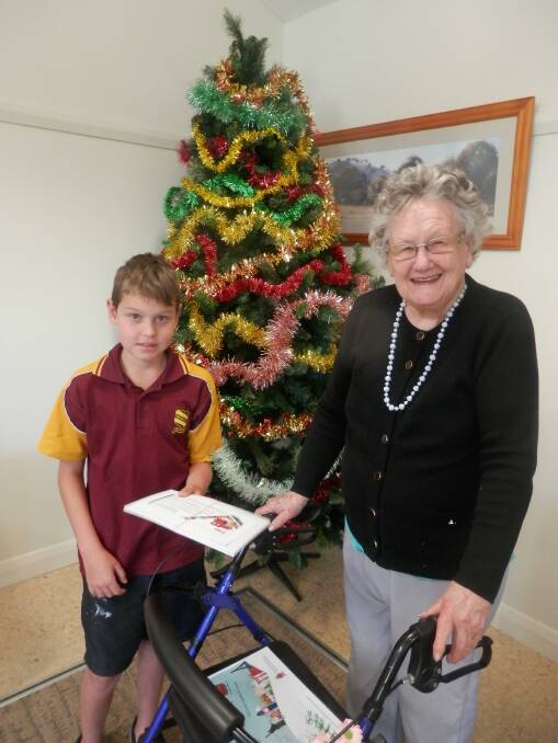 CREATE: Wamoon Public School student William Morton was the winner of the Christmas card competition. He is congratulated by Leeton Masonic Village resident Amy Ward. Photo: Contributed 