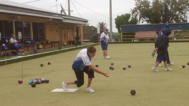 ACTION: Dian Colyer on the mat as she watches her shot roll away. Photo: Supplied