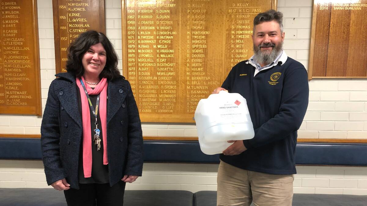 HEALTHY: Toorak Winery's Robert Bruno (right) delivers the hand sanitiser to Leeton High principal Meagan Crelley. Photo: Talia Pattison