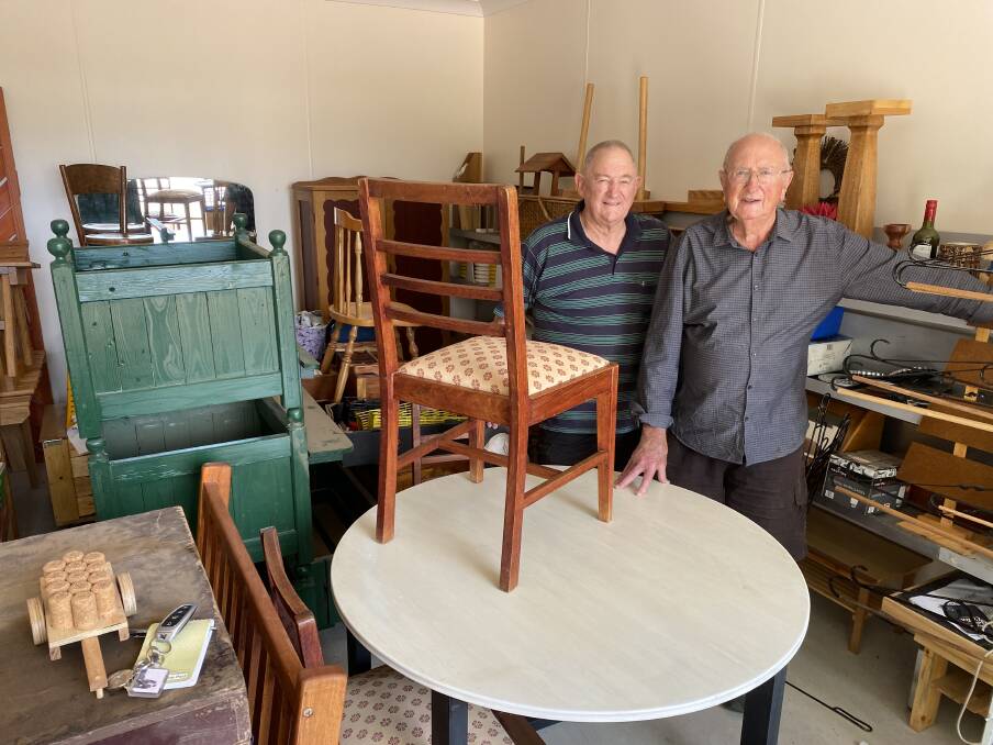 Leeton Men's Shed members Jim Milne (left) and David Carn with some of the items on offer at the garage sale. Picture by Talia Pattison