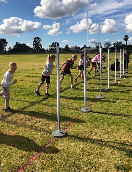TEST RUN: Some of Leeton's young athletes have a go at using the new equipment at the high school ovals recently. Photo: Contributed 
