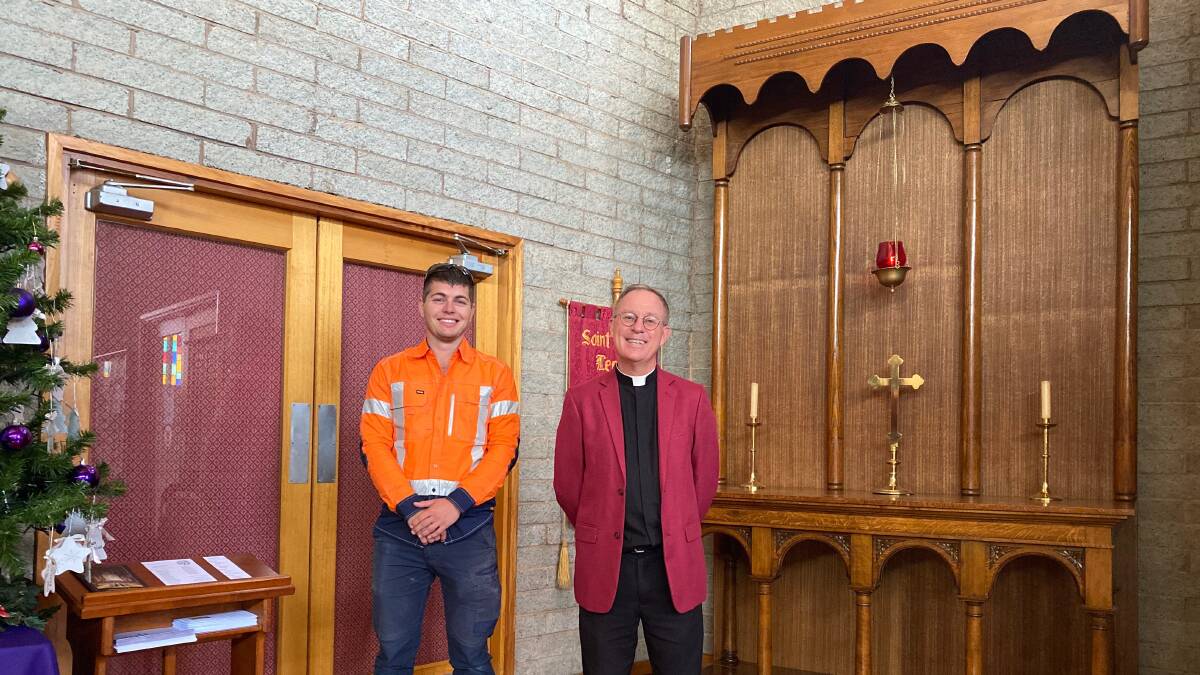 RESTORED: David Annetts from the All Pro Group with Father Robert Murphy and the refurbished altar from the St John's church in Whitton. Photo: Talia Pattison
