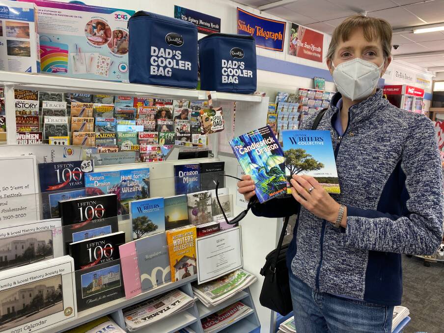 A WRITER'S WORLD: Author Melanie Ifield with one her books available at the Leeton Newsagency, as well as the latest publication from the Leeton Writers Collective, which is a member of. Photo: Talia Pattison
