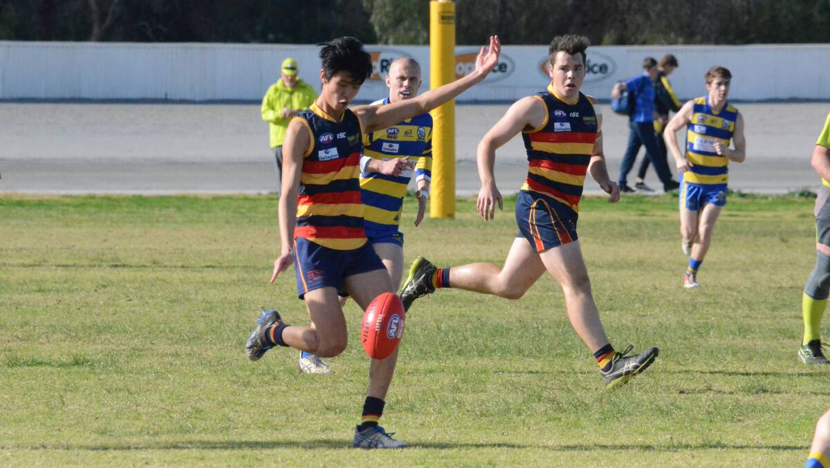 BOOT TO BALL: Leeton-Whitton's Jay Tang gets the ball away during a match last season. 