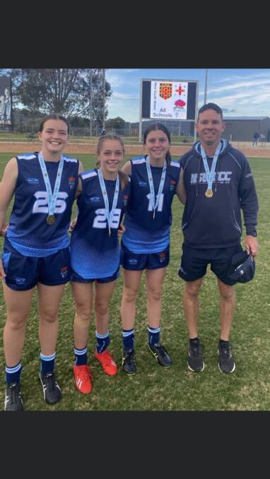 AWARD: St Francis College teacher James Sullivan (far right) with Emily Baulch, Imogen Bonny and Timeeka Coleman after their team's state win earlier this year. Photo: Supplied
