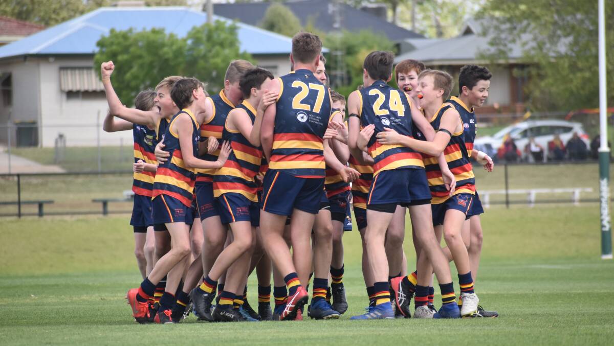 WINNERS: The under 13s celebrate their grand final win on the weekend. Photo: Liam Warren