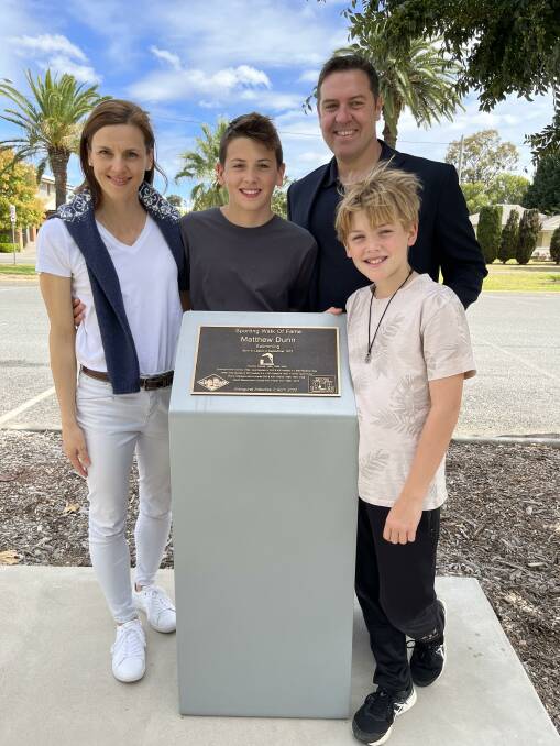 ON AGAIN: Matthew Dunn (right) with his family and plaque unveiled in his honour after he was one of the inaugural inductees into the sporting walk of fame. Photo: Supplied