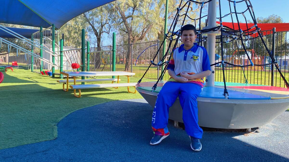 HELP OUT: Gralee School student Jackson Uren loves using the playground, with fundraising underway for new artificial turf. Photo: Talia Pattison
