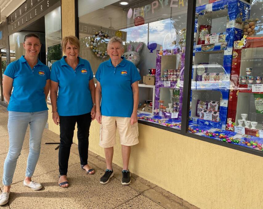 FESTIVE: Julie Axtill, Cheryl Whymark and Denise McGrath outside one of the many shop windows decorated for the festival. Photo: Talia Pattison 