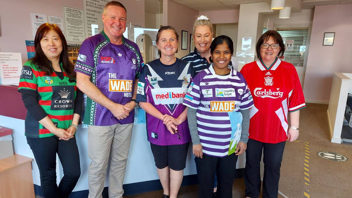 FOOTY COLOURS: Leeton Medical Centre staff (from left) Dongmei Wang, Simon Wallace, Christine Hedditch, Sarah Day, Sathya Adusumilli and Ruth Warren show their sporting alliances for a cause.