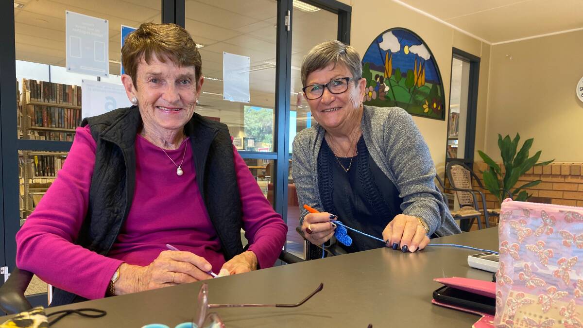 BACK AT IT: Group members June Hillier (left) and Pat Horton have been enjoying being back in the library again as part of the knitting group. Photo: Talia Pattison