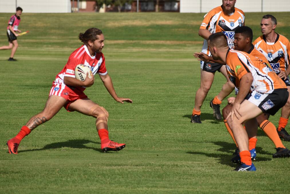 BRACE: Wade Williams runs straight towards the Tigers defence on Friday evening. Photo: Shaun Paterson 