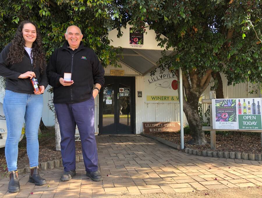 ANOTHER FEATHER IN THE CAP: Gianna (left) and Robert Fiumara from Lillypilly Estate Wines with the championship wine and medal. Photo: Talia Pattison