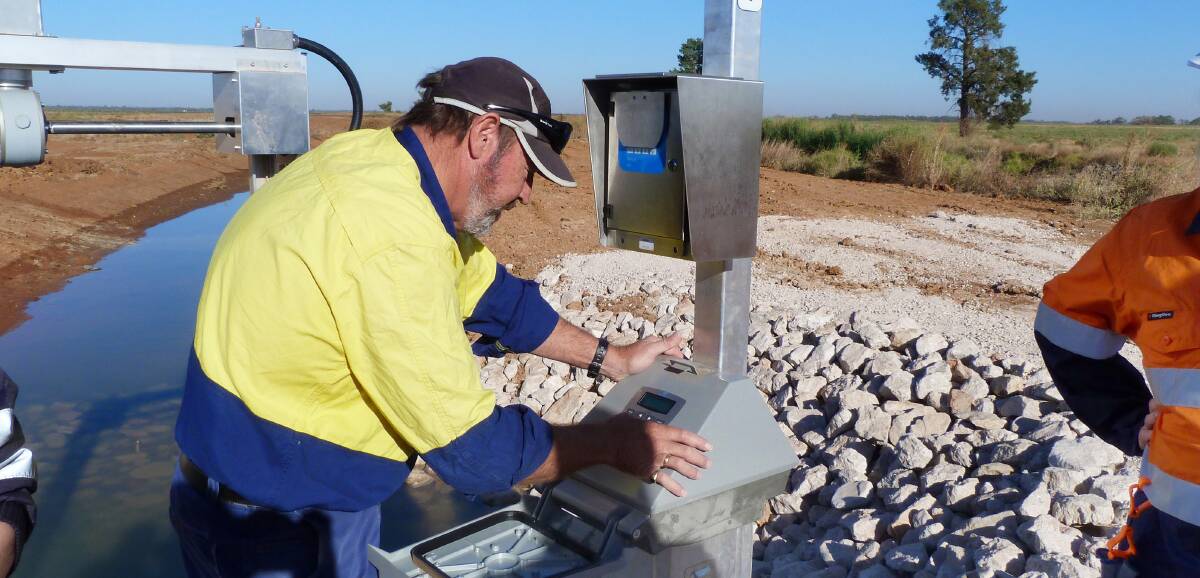 Murrumbidgee Irrigation division operator Phil Hurst inspects one of the new automated meters providing real time data on customer water use. Photo: Contributed