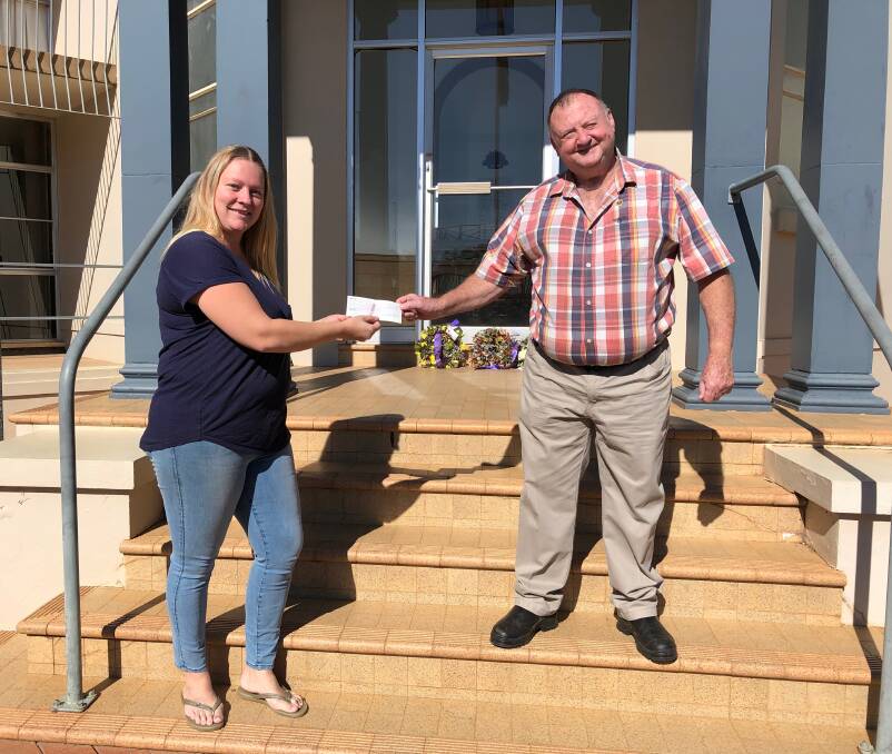 HANDOVER: Quest entrant Belinda Mahalm presents Leeton RSL Sub-branch president Peter Williams with the fruits of her fundraising. Photo: Talia Pattison