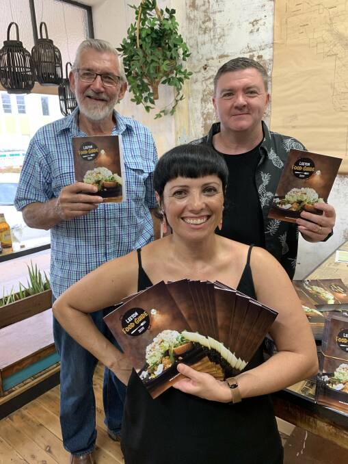 JOB DONE: Vanessa Pages (front), with mayor Paul Maytom (back left) and Leeton Business Chamber president Wayne Bond with the new Leeton Food Guide at the recent launch. Photo: Contributed 