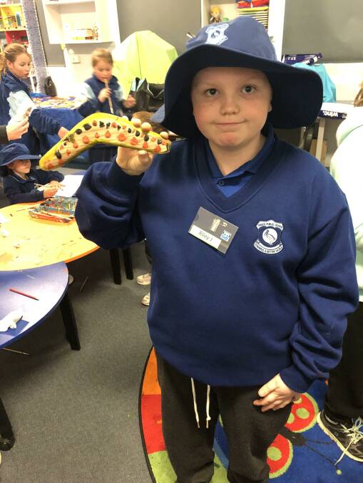 LEARNING: Yanco Public School year four student Riley Jackson with his painted boomerang during recent NAIDOC activities. Photo: Contributed 