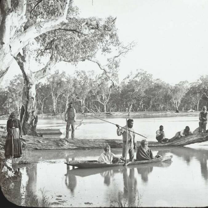 STORY: Aboriginal people fishing from the banks and a bark canoe, Murray River 1886 trying to live in two worlds, living a traditional life while wearing European clothes. Photo: National Liibrary of Australia
