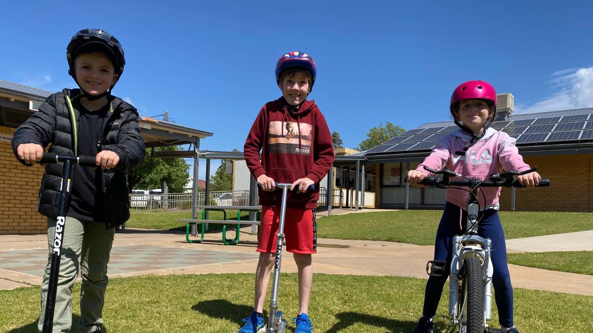ACTIVE: Leeton Out of School Care attendees (from left) Brax Dellafranca, Nikolas Irrang-Cashel and Imogen Boots had fun during the bike and scooter day. Photo: Talia Pattison 