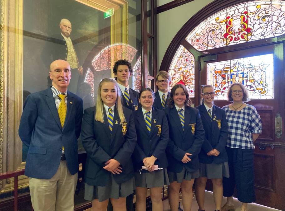 LEARN: Former YAHS student and teacher Bill Barwick (left) and relieving principal Lisa O'Brien (right) with the current school leadership group in front of the Sir Samuel McCaughey portrait. Photo: Talia Pattison