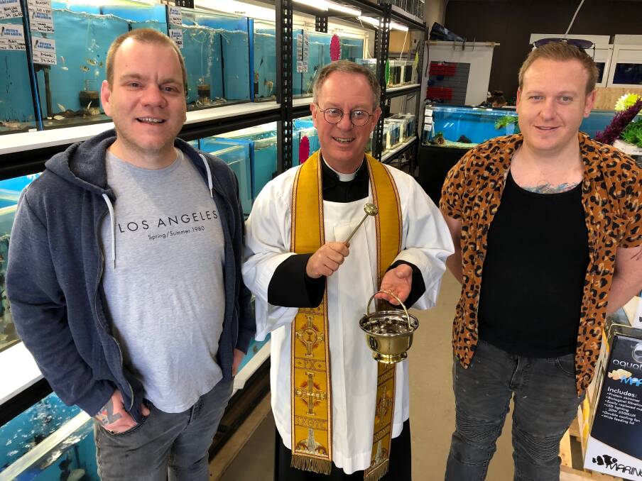 PREPPED: Chris (left) and Peter Melidonis with Father Robert Murphy at Pete's Aquarium ahead of this weekend's Blessing of the Pets at the Leeton Show. Photo: Talia Pattison 