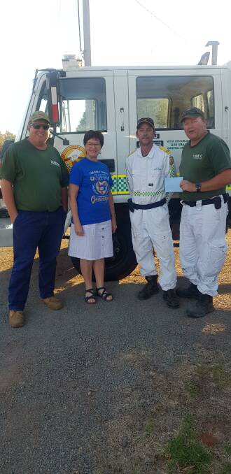 GRATEFUL: Alanna Rolfe (second from left) presents the funds to Glen, Jason and Paul from the Leeton Volunteer Rescue Association. 