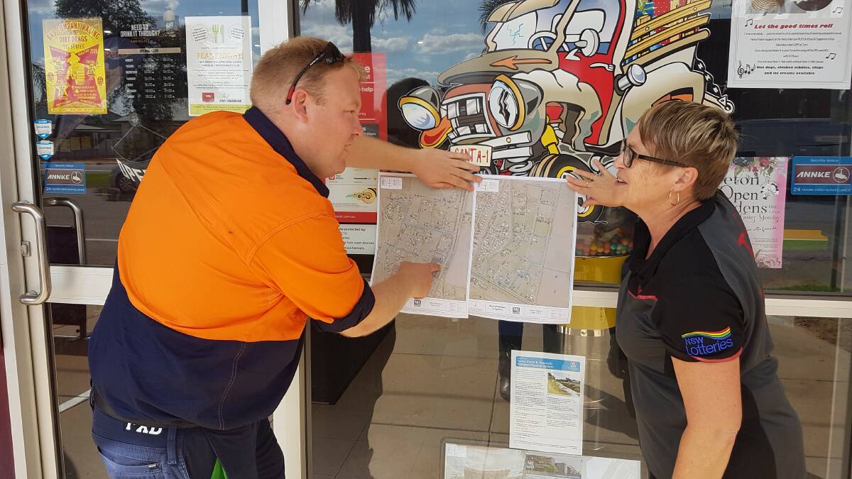 INFORM: MI engagement officer Michael Waanders points out the Yanco works to Julie Heath at the Yanco Store. Photo: Contributed 
