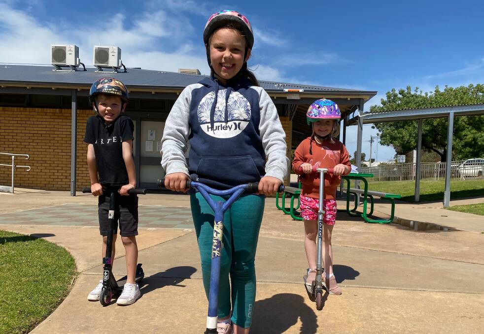 GREAT TIMES: Chace Wellington, Shelby Hawkins and Elodie O'Donnell enjoyed the bike and scooter day at Leeton Out of School Care. Photo: Talia Pattison