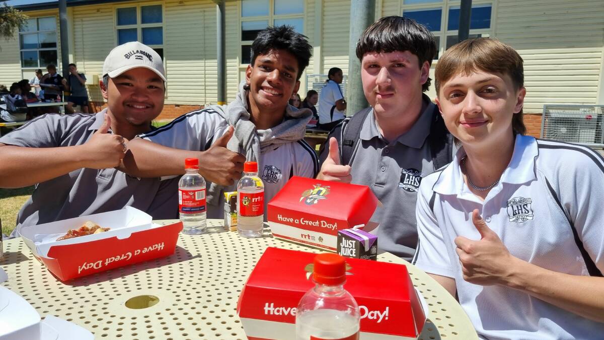 Leeton High School students give a big thumbs up to the delicious burgers cooked up by the Leeton Rapid Relief Team as part of the day's events. Picture supplied 