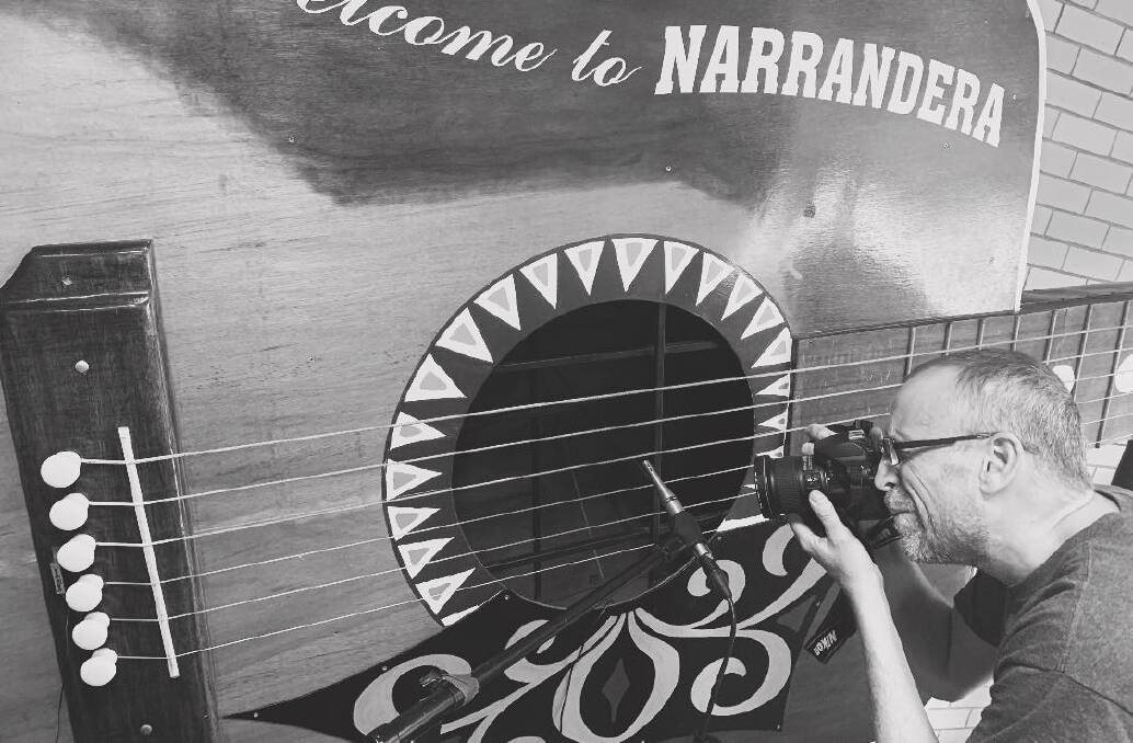 LISTEN UP: Leeton's Jason Richardson in action during the project to record the big guitar in Narrandera. Photo: Contributed 