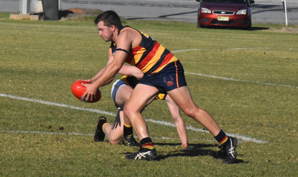 MATCH UP: Tom Handsaker prepares to get the ball away during Leeton-Whitton's earlier game this season against the Wagga Tigers. Photo: Liam Warren