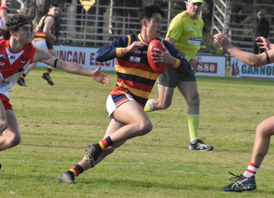CHASE: Leeton-Whitton's Jay Tang evades the Griffith defence last weekend. Photo: Liam Warren