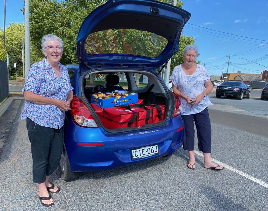 LOCKED AND LOADED: Leeton sisters Jenny (left) and Kate love their role as Meals on Wheels volunteers within the community. Photo: Talia Pattison 
